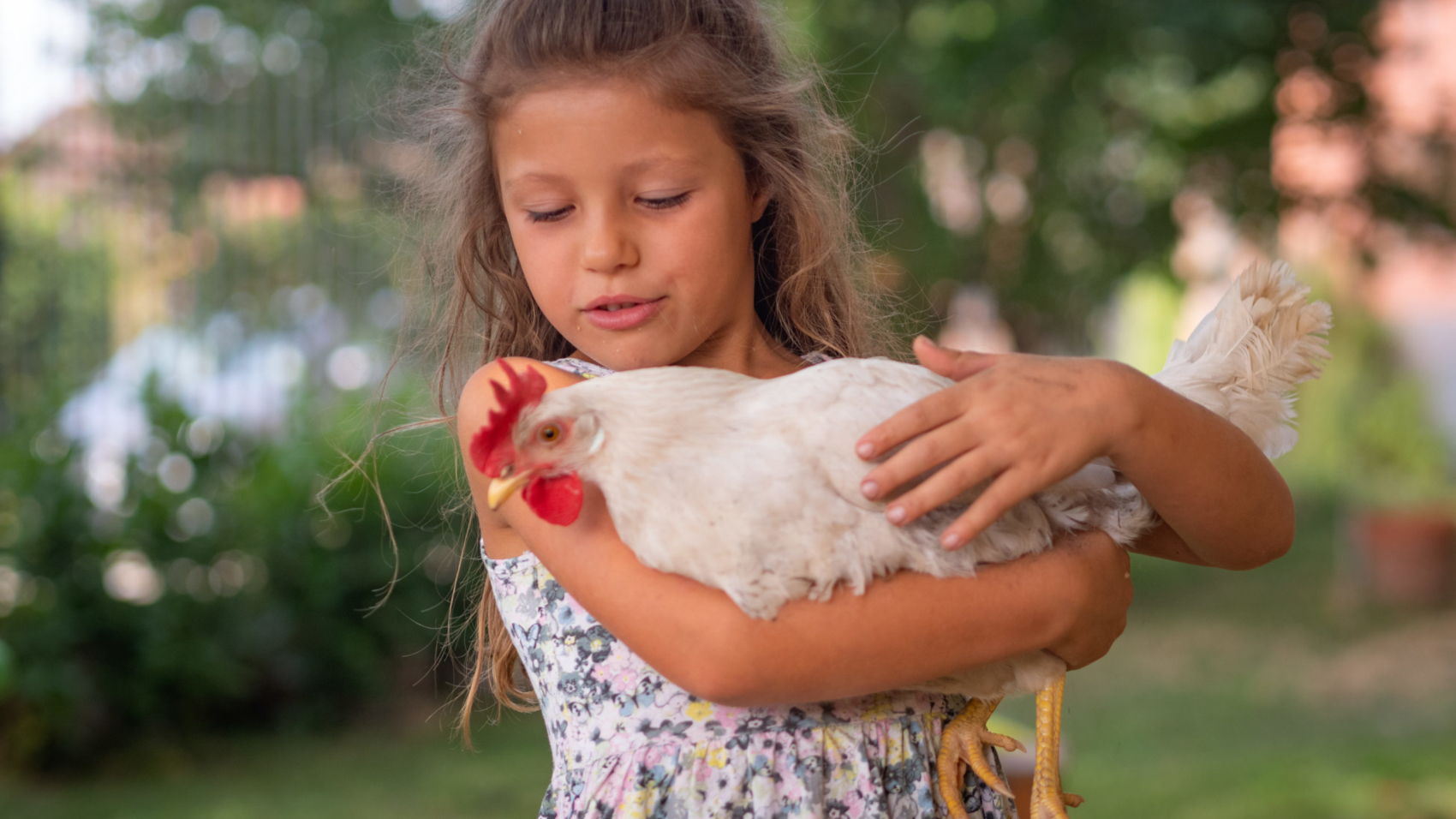 Authentic moment of happy little smiling girl is holding a white